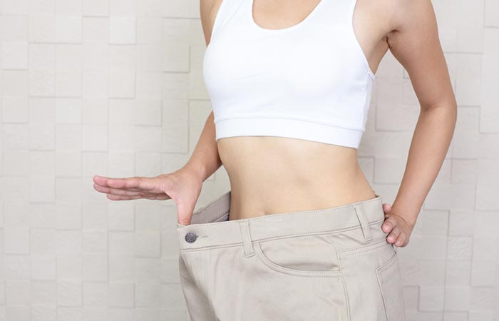 Woman showing weight loss after completing scarsdale diet