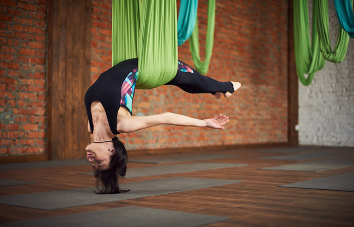 Woman practicing body inversion, anti-gravity aerobic exercise