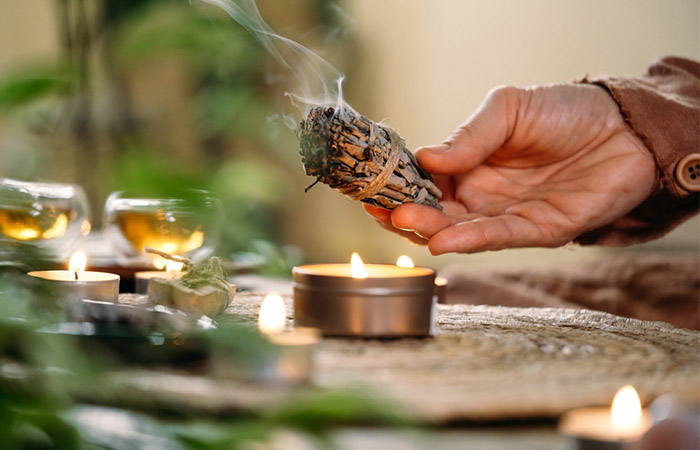 Woman burning sage for its health benefits