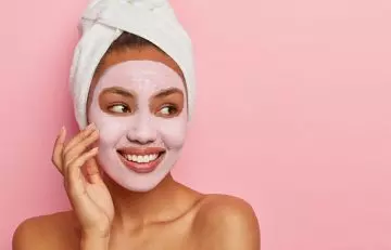 Woman using milk of magnesia as face mask