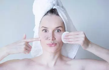 Woman removing blackheads with milk of magnesia 