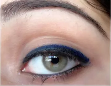 Step 5 of applying blue eyeliner