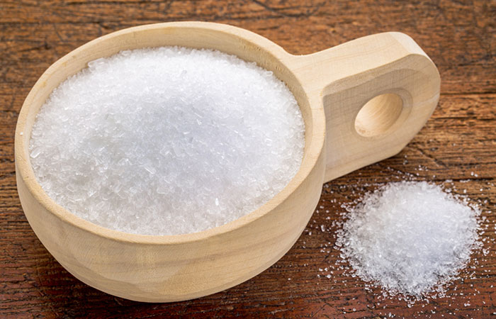 Epsom salt in a wooden cup for a therapeutic bath to manage edema