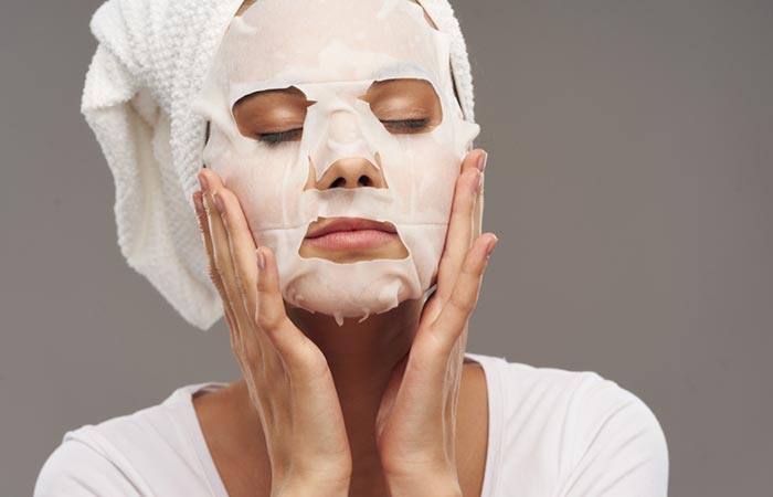 Woman applying face mask to look younger