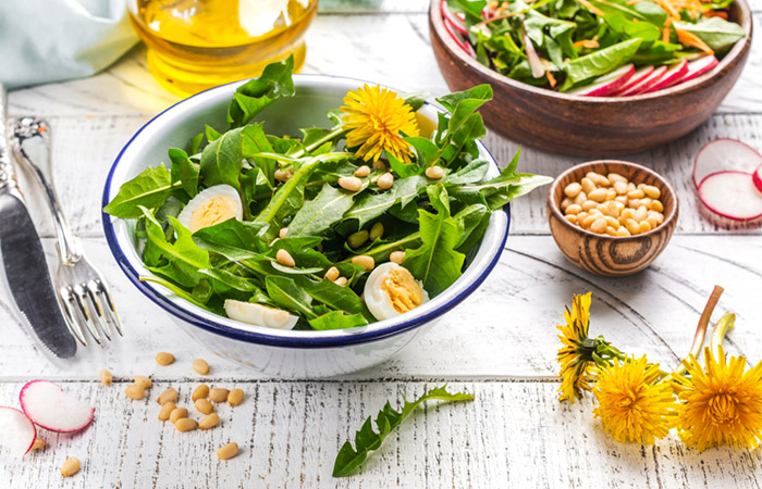 Salad with fresh dandelion leaves, eggs, and nuts.
