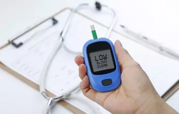 Glucose meter indicating low blood sugar due to triphala consumption