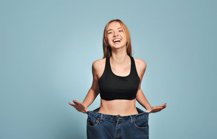 Woman feeling happy with her weight loss