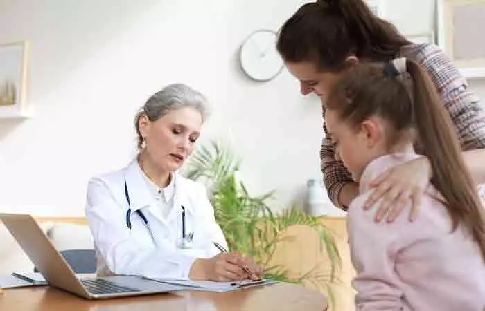 Mother and child consulting doctor for hair loss