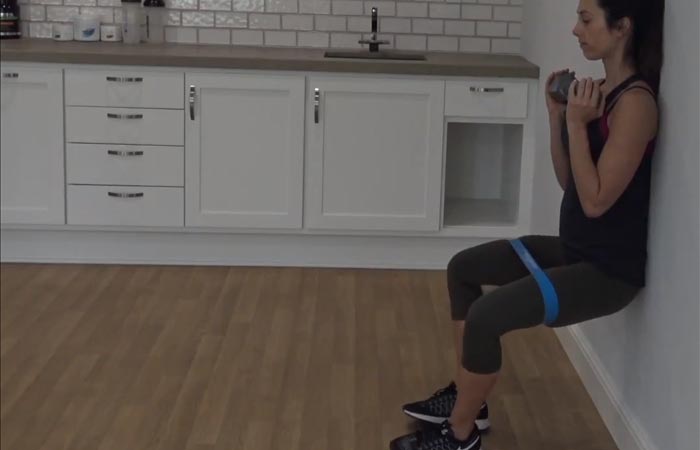 Wall sit with resistance band
