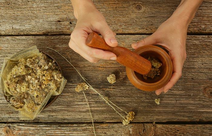 Closeup of hands preparing DIY remedy for hair loss