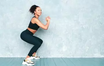 Squats as one of the exercises for toned thighs