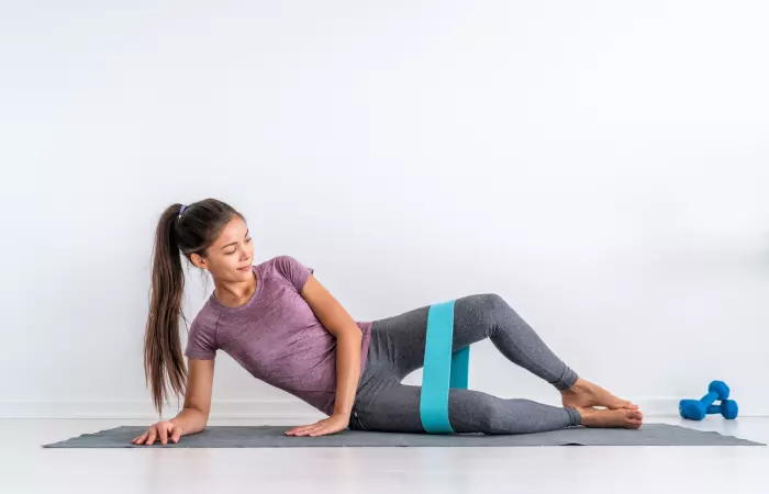 Young woman practicing clamshell exercise