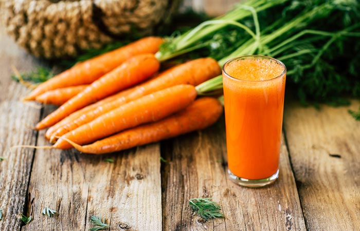 Glass of carrot juice with carrots