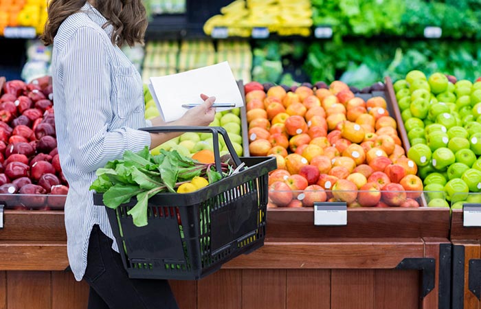 Woman in the mart shopping for nutritious food from her diet checklist