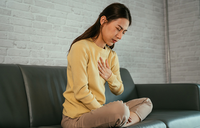 Woman suffering with heartburn