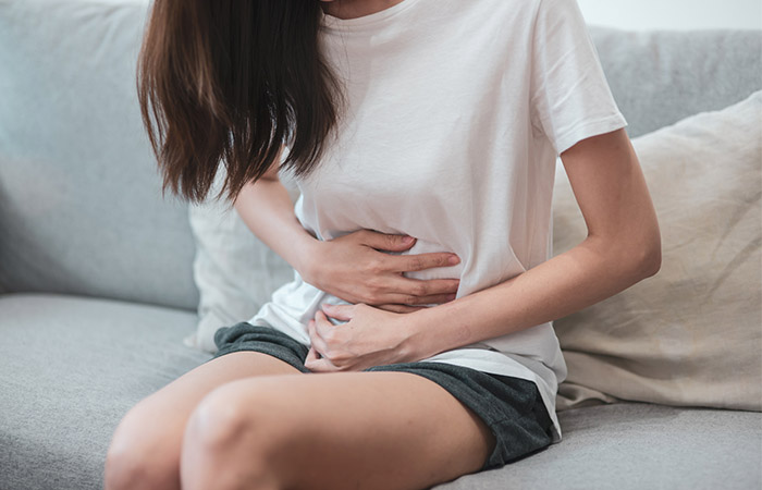 Woman with stomach discomfort and cramping