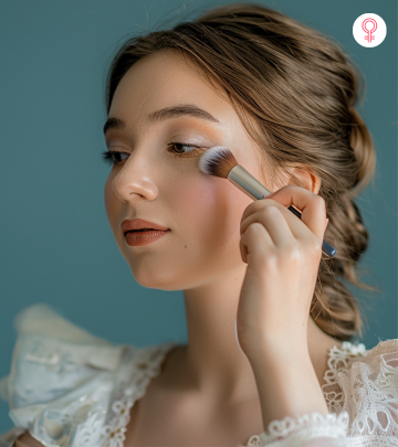 An older women applying makeup on her face