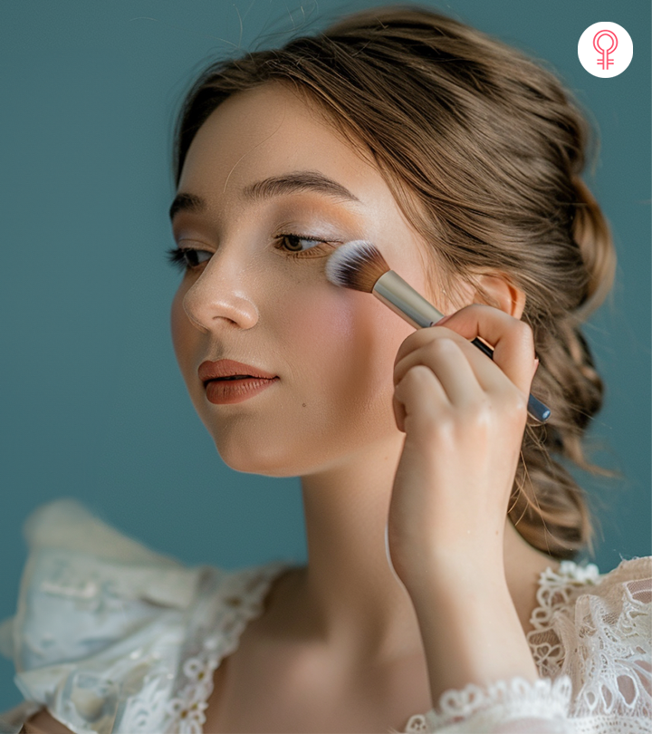 Women applying makeup in front of mirror