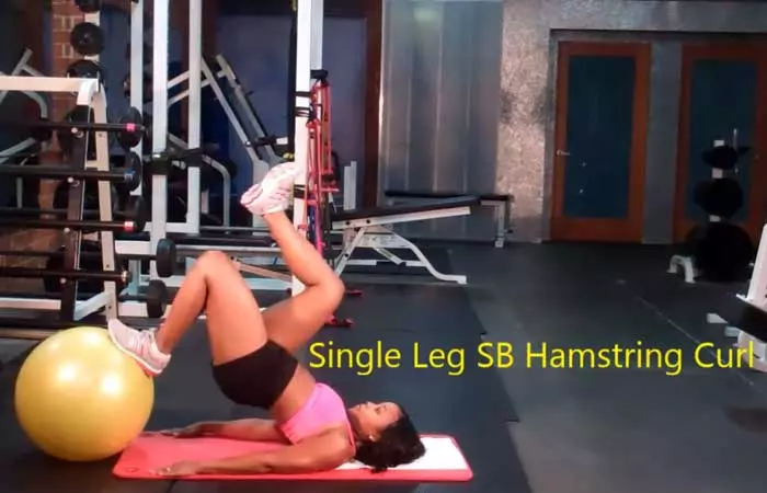 Single leg stability ball hamstring curl bridge exercise