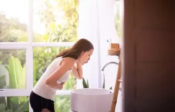 Woman vomiting due to vitamin A toxicity