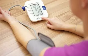 Woman checking her low blood pressure