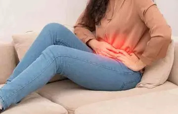 A woman experiencing abdominal pain due to diarrhea