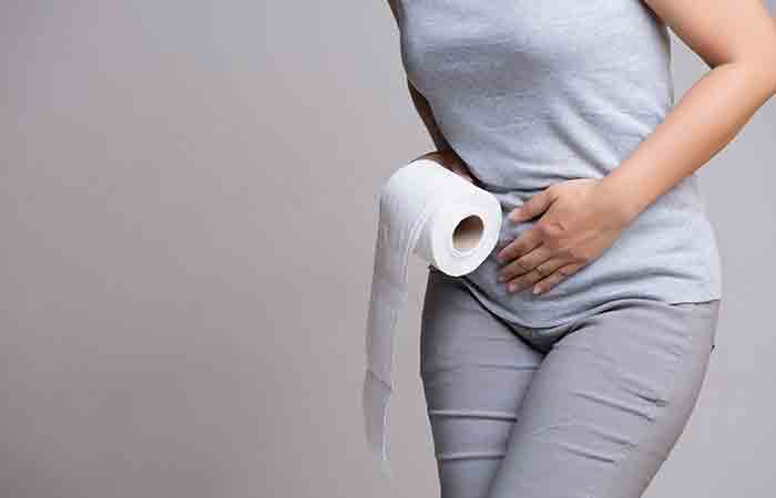Woman experiencing diarrhea as a side effect of having honey