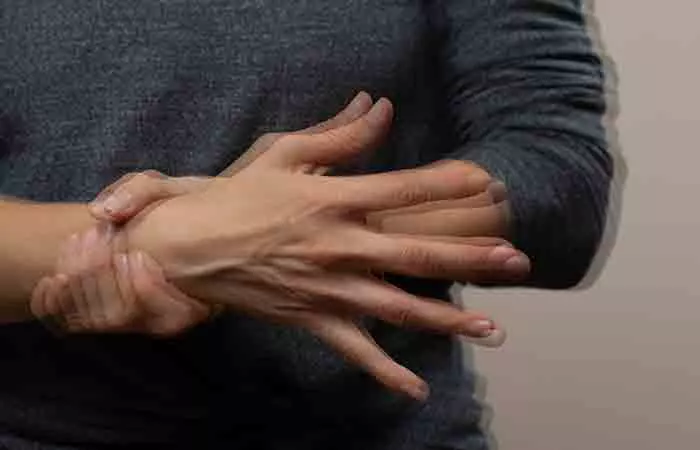 A woman experiencing hand tremors