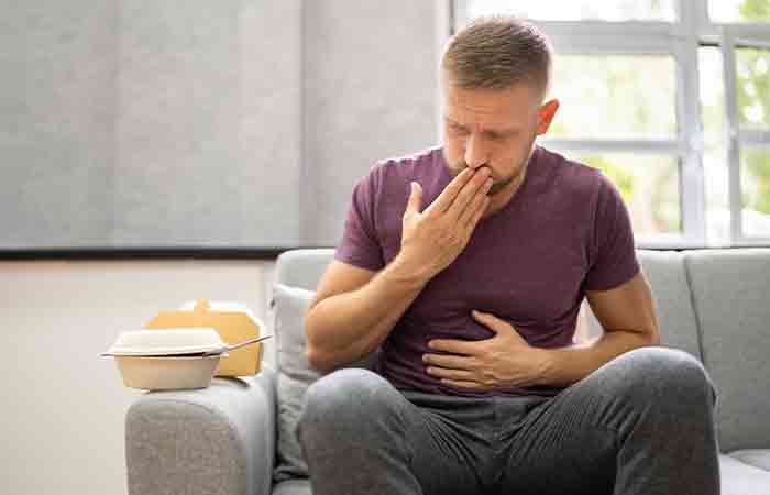 Man holding his mouth and belly due to indigestion problem as a side effect of peppermint tea