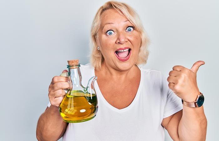 Woman holding a bottle of olive oil