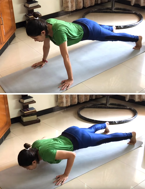 Woman doing push-ups on a yoga mat to exercise her arms without weights