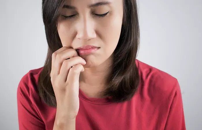 Close up of a woman having itching sensation in the mouth as an allergic reaction due to side effects of avocados