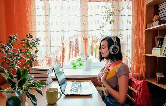 Woman listening to mantras while meditating