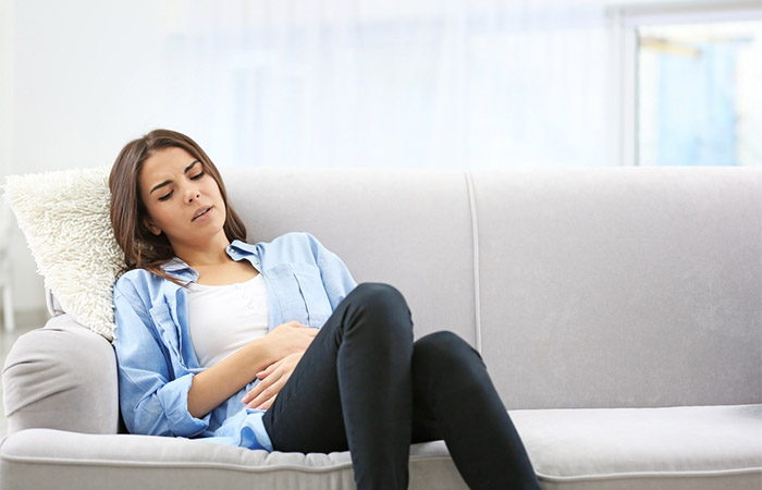 Woman suffering with abdominal cramps