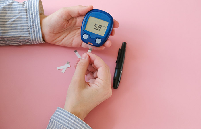 Woman checking blood sugar levels as dates may affect them