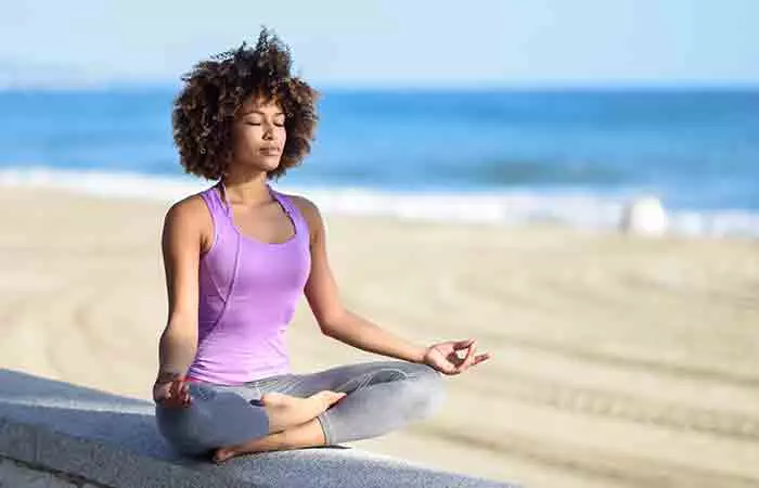 Young woman doing yoga using pranic healing techniques