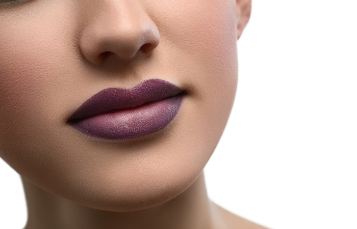 Young woman with deep plum lipstick