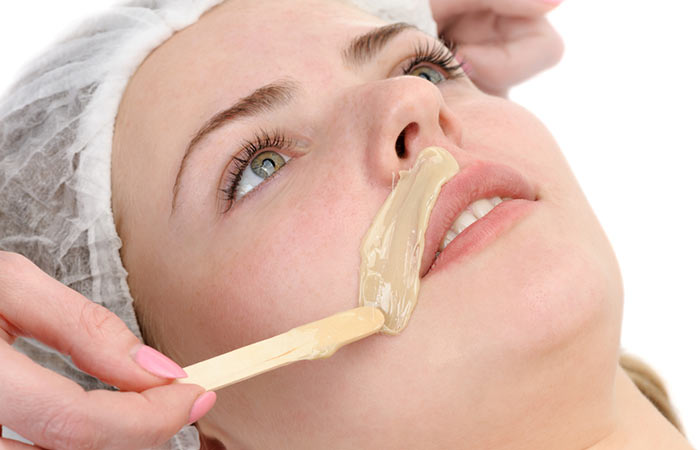 Waxing to remove white facial hair