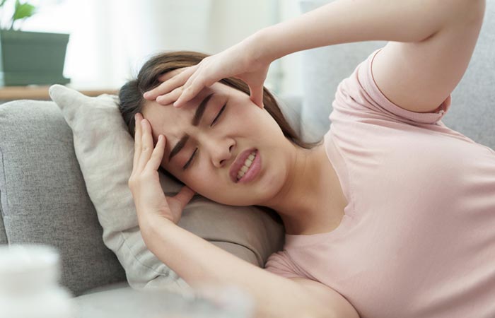 Woman with headache from pineapple side effect