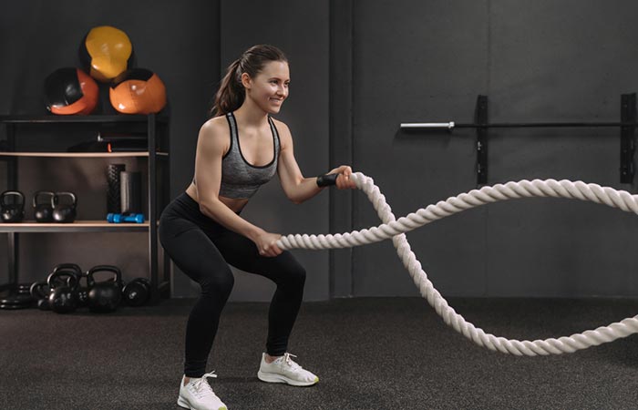Woman using ropes to increase her stamina