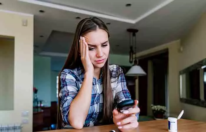 Woman looking worried as she reads her blood sugar test