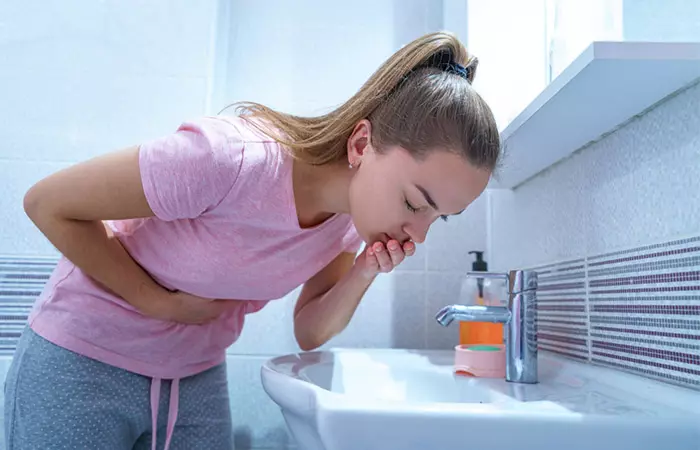 Woman vomiting due to the side effects of mung beans.