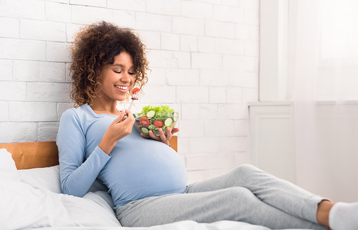 Pregnant woman eating organic salad