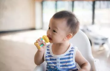 Baby sucking chewelry instead of thumb