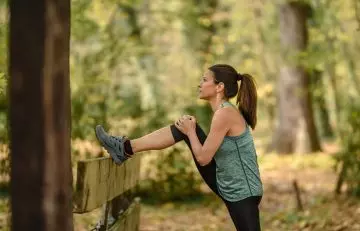 Woman stretching to warm up before run