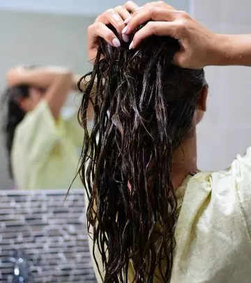 Woman applying hair mask to treat hair loss