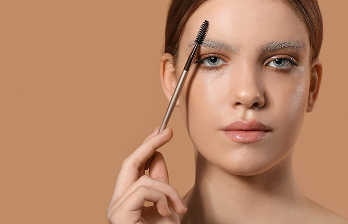 Woman holding eyebrow brush