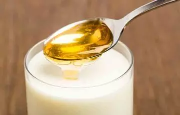 A glass of warm milk with a tablespoon of honey as a weight loss drink