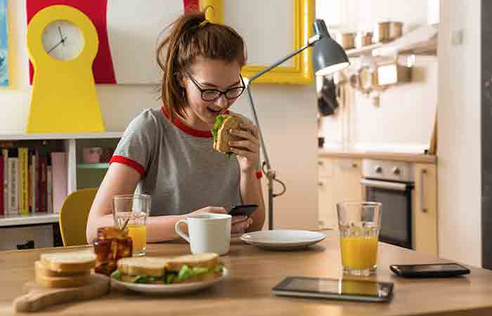 Teen girl enjoys a hearty breakfast which is crucial for weight management