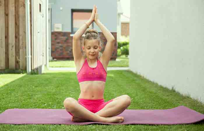 Teen girl during a yoga session that ensures healthy metabolism for weight loss